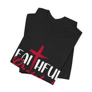 A folded black t-shirt with a graphic print on the front. The design features the words 'FAITHFUL' in bold white letters overlaid with a red cross and red brushstroke details, set against a plain white background.