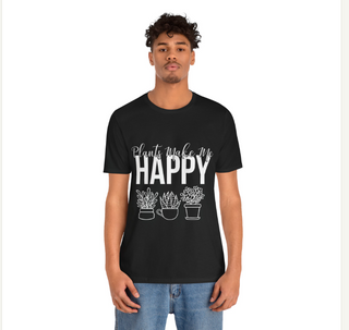 A man wearing a black short-sleeve t-shirt with a white graphic print that reads 'Plants make me HAPPY' above three simple potted plant illustrations, paired with blue jeans, against a plain white background.