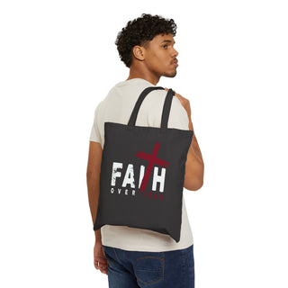 Faith Over Fear Christian black tote bag with inspirational faith design showing model holding bag.